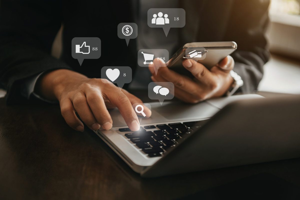 Businessman working with smartphone and digital laptop computer. 2024 Omnichannel Messaging Trends Wrapped