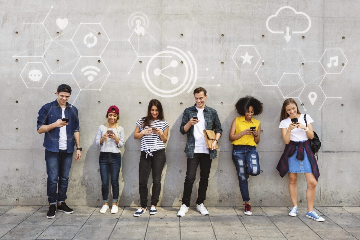 Diverse people using their phones Avoid Mistakes in Omnichannel Messaging Success