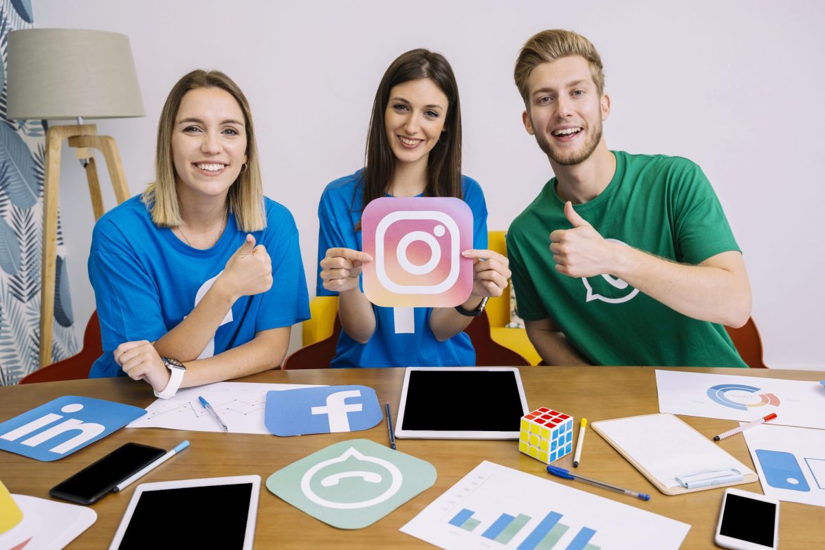 woman-holding-instagram-like-icon-with-his-friends-showing-thumbup-sign Success Stories: Outsourcing Social Media Management