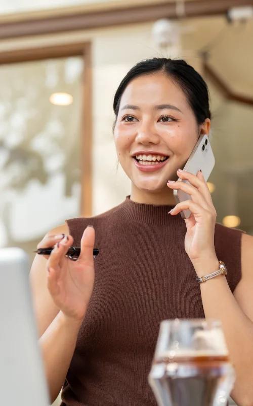 beautiful-confident-asian-woman-talks-phone-while-working-remotely-from-cafe beautiful-confident-asian-woman-talks-phone-while-working-remotely-from-cafe
